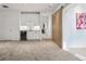 Spacious living room features a stylish dry bar with a wine cooler and a unique sliding barn door at 14 S Grape St, Denver, CO 80246