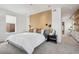 Serene main bedroom features a wood accent wall, plush carpeting, and leads to the en-suite bathroom at 14 S Grape St, Denver, CO 80246