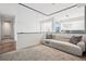 Upstairs lounge area featuring a modern couch, neutral carpeting, and a large mirror offering a spacious feel at 14 S Grape St, Denver, CO 80246