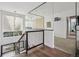 Open staircase featuring metal railings, wood steps, and ample natural light leading to the upper levels at 14 S Grape St, Denver, CO 80246