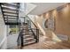 Open staircase with metal railings features wood and carpet steps leading to a light-filled upper level at 14 S Grape St, Denver, CO 80246