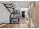 Modern staircase with metal railings, wood accents, and large windows providing natural light at 14 S Grape St, Denver, CO 80246