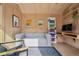 Stylish studio interior features a comfortable sofa, sleek desk, and plywood paneling for a modern look at 14 S Grape St, Denver, CO 80246