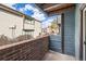 Outdoor balcony features wood paneled walls and brick trim and looks out over the complex at 11913 E Harvard Ave # 106, Aurora, CO 80014