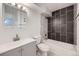 Updated bathroom featuring modern vanity, toilet, and newly tiled bath and shower combination at 11913 E Harvard Ave # 106, Aurora, CO 80014