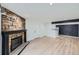 Cozy living room featuring wood flooring and a stone fireplace at 11913 E Harvard Ave # 106, Aurora, CO 80014