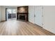 Living room featuring wood floors and a stone fireplace at 11913 E Harvard Ave # 106, Aurora, CO 80014