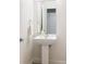 Modern powder room features pedestal sink with designer faucet and large mirror at 2880 Zuni St # 308, Denver, CO 80211