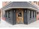 Cozy brick building with a unique wooden door and warm lighting at 2880 Zuni St # 308, Denver, CO 80211