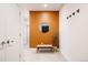 Inviting hallway with a minimalist design, featuring a bench, mirror, and hooks at 2880 Zuni St # 308, Denver, CO 80211