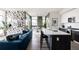 Open-concept living room with stylish decor, a kitchen island and plenty of natural light at 2880 Zuni St # 308, Denver, CO 80211