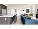 Bright, open living space featuring a kitchen island with seating and comfortable lounge area at 2880 Zuni St # 308, Denver, CO 80211