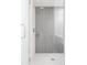 Modern glass shower showcasing sleek gray tile and a rainfall showerhead fixture at 2880 Zuni St # 308, Denver, CO 80211