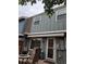 Back exterior view of home with awning, chairs, and flagstone patio at 9060 E Cherry Creek South Dr # E, Denver, CO 80231