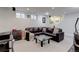 Finished basement featuring a leather sofa, glass coffee table, and small windows at 9060 E Cherry Creek South Dr # E, Denver, CO 80231