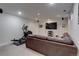 Spacious finished basement with an entertainment center, workout equipment, and carpeted floors at 9060 E Cherry Creek South Dr # E, Denver, CO 80231