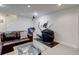Finished basement with leather sofa, elliptical machine, and glass coffee table at 9060 E Cherry Creek South Dr # E, Denver, CO 80231