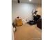View of the basement area with carpet, elliptical machine and storage at 9060 E Cherry Creek South Dr # E, Denver, CO 80231