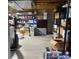 Unfinished basement area with storage shelving and concrete floor at 9060 E Cherry Creek South Dr # E, Denver, CO 80231
