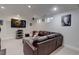 Spacious finished basement with leather sofa, television, and small windows at 9060 E Cherry Creek South Dr # E, Denver, CO 80231