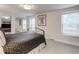 Serene bedroom with mirrored closets offering ample storage, complemented by bright windows and warm decor at 9060 E Cherry Creek South Dr # E, Denver, CO 80231