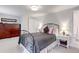 Cozy bedroom featuring a wrought iron bed frame, complemented by bedside tables and ample storage at 9060 E Cherry Creek South Dr # E, Denver, CO 80231