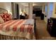 Comfortable bedroom with a red and white quilt and mirrored closet at 9060 E Cherry Creek South Dr # E, Denver, CO 80231