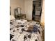 Bedroom featuring a vanity and an open closet with shelving units at 9060 E Cherry Creek South Dr # E, Denver, CO 80231