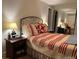 Comfortable bedroom with a red and white quilt and mirrored closet at 9060 E Cherry Creek South Dr # E, Denver, CO 80231