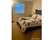 Comfortable bedroom with a black-framed bed and a window with blinds at 9060 E Cherry Creek South Dr # E, Denver, CO 80231
