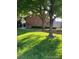 Brick building on a sunny, grassy lawn with trees in a residential area at 9060 E Cherry Creek South Dr # E, Denver, CO 80231