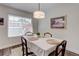 Dining room featuring an elegant table with a large window at 9060 E Cherry Creek South Dr # E, Denver, CO 80231