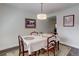 Bright dining room featuring a white tablecloth, pendant lighting, and wood floors at 9060 E Cherry Creek South Dr # E, Denver, CO 80231