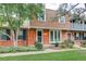 Brick townhome with manicured lawn and mature trees at 9060 E Cherry Creek South Dr # E, Denver, CO 80231