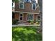 Charming two-story brick home with a well-manicured lawn and lush landscaping at 9060 E Cherry Creek South Dr # E, Denver, CO 80231