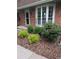 Well-maintained front yard featuring lush green landscaping and a brick facade at 9060 E Cherry Creek South Dr # E, Denver, CO 80231