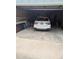 Attached garage with a white car inside; storage area and ladder visible at 9060 E Cherry Creek South Dr # E, Denver, CO 80231