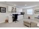 Bright home office featuring built-in cabinets, drawers, and a comfortable seating area, perfect for remote work at 9060 E Cherry Creek South Dr # E, Denver, CO 80231