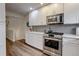 Modern kitchen with subway tile backsplash, granite countertops, and stainless-steel appliances at 9060 E Cherry Creek South Dr # E, Denver, CO 80231