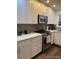 Modern kitchen with stainless steel appliances, white cabinets, and elegant countertops at 9060 E Cherry Creek South Dr # E, Denver, CO 80231