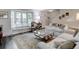 Bright living room with a bay window and staircase at 9060 E Cherry Creek South Dr # E, Denver, CO 80231