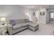 Comfortable living room with a patterned sectional sofa and view of adjacent rooms at 9060 E Cherry Creek South Dr # E, Denver, CO 80231