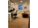 Bright office area with built-in shelves and a comfortable sitting area at 9060 E Cherry Creek South Dr # E, Denver, CO 80231