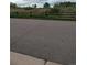 Asphalt roadway with grassy field and split rail fence in background at 9060 E Cherry Creek South Dr # E, Denver, CO 80231