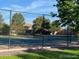 Community tennis court surrounded by mature trees, providing a recreational amenity for residents at 9060 E Cherry Creek South Dr # E, Denver, CO 80231