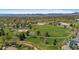 Overhead view of a community park with sports field, pond, and playground surrounded by trees at 1568 S Dudley Ct, Lakewood, CO 80232