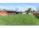 Expansive backyard with well-maintained lawn, brick garage, and a cozy home at 1568 S Dudley Ct, Lakewood, CO 80232
