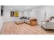 Finished basement with seating, hardwood floors and stylish decor at 1568 S Dudley Ct, Lakewood, CO 80232