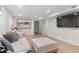 Comfortable basement with an oversized couch, plush decor and TV at 1568 S Dudley Ct, Lakewood, CO 80232