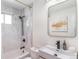 Stylish bathroom with marble tile, a black shower head, and gold accents at 1568 S Dudley Ct, Lakewood, CO 80232